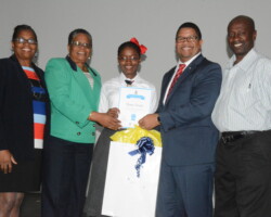Essay winner receives prize. L-R, Mrs. Bevans Hanna (V.P Mary Star of The Sea), Mrs. Rosemary Pintard-Bowe (Acting D.I.R Controller), Yana Swain (Awardee), Hon. K. Peter Turnquest (DPM, Min Of Finance), Mr. Denzal Swain (father of awardee)
